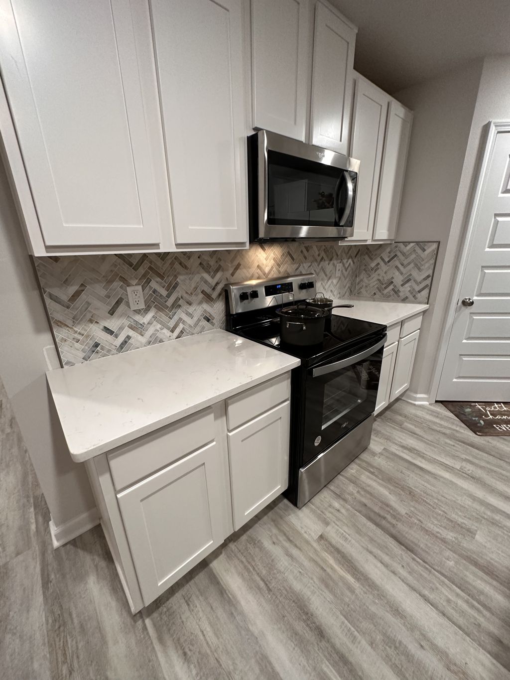 A beautiful natural stone herringbone backsplash c