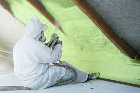 Insulating with spray foam in an attic.