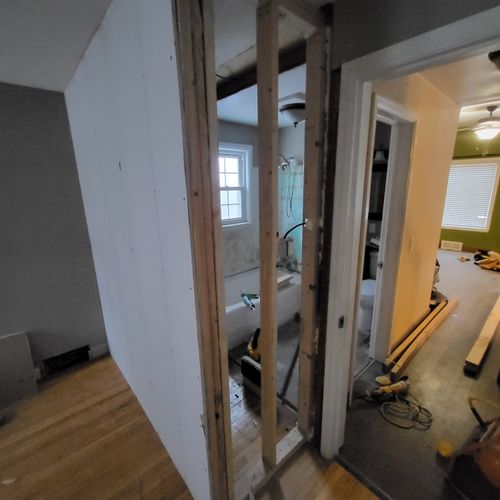 Framing wall to extend bathroom (during) 