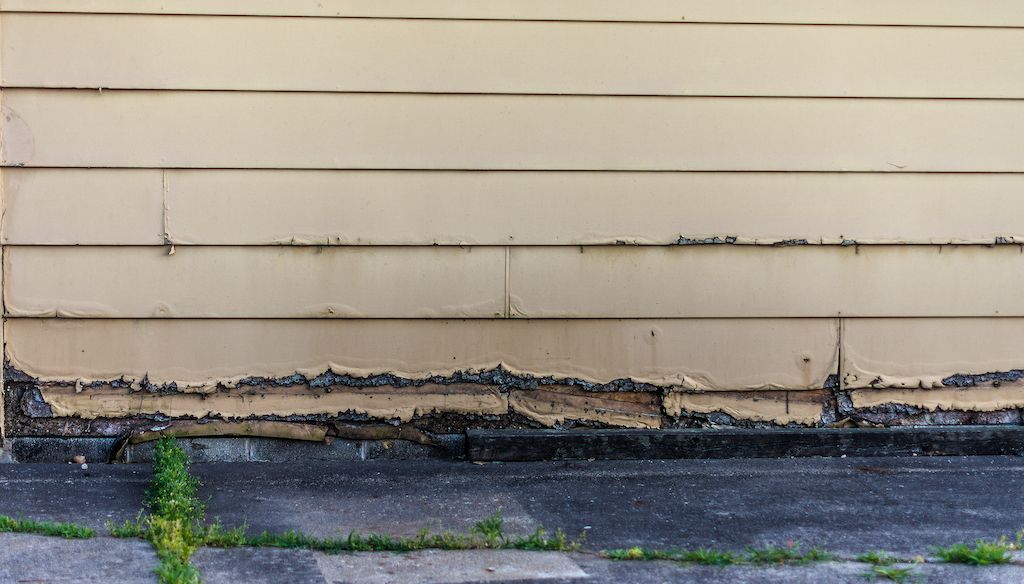 water damage and wood rot on garage siding