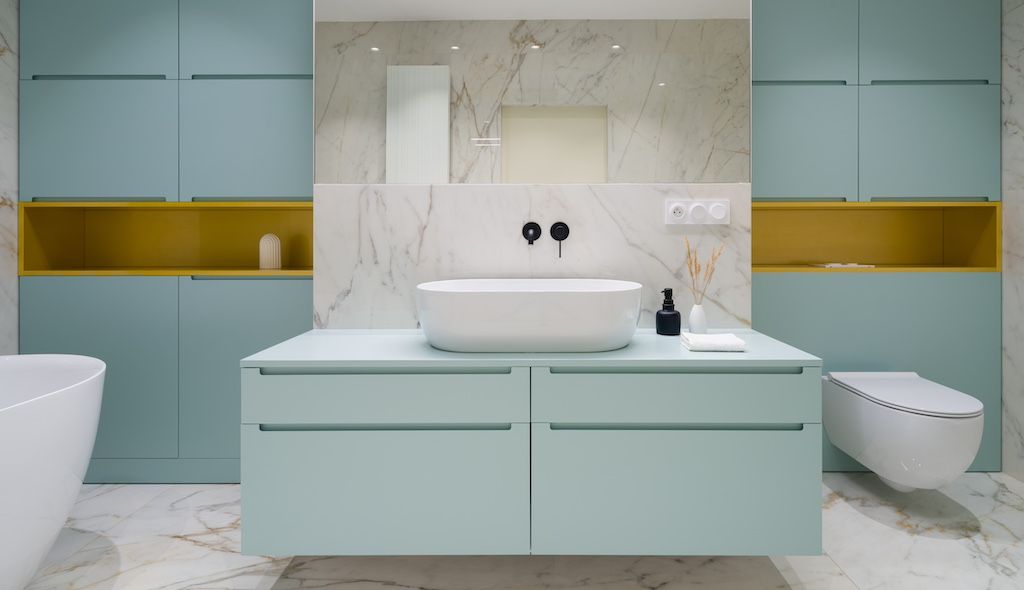 blue bathroom with shelves and cabinets