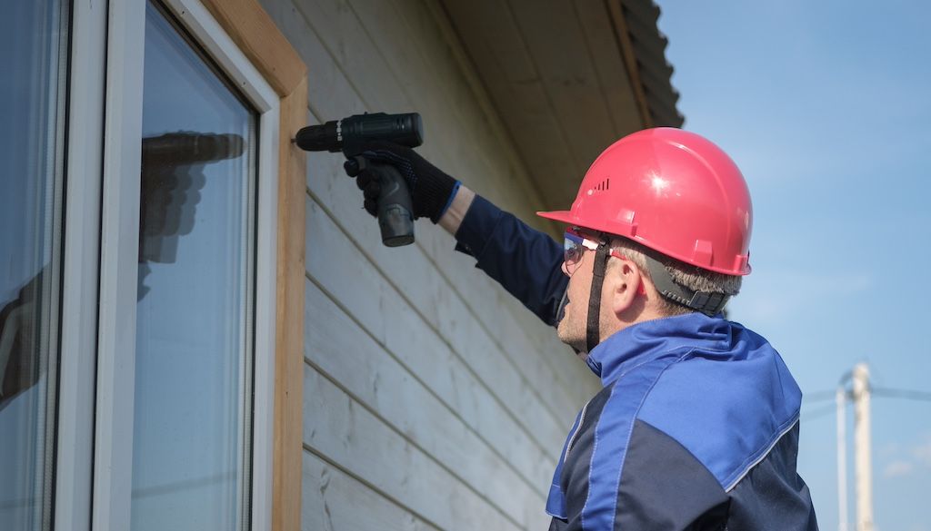 professional installing window capping or cladding