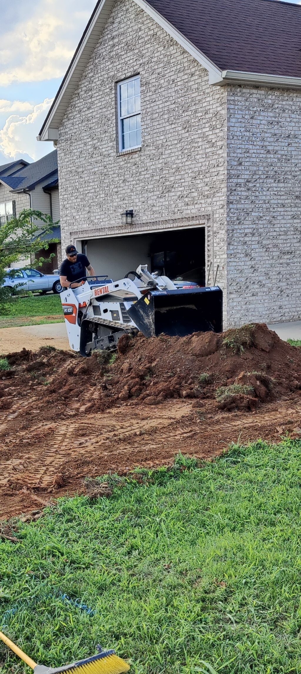 Removing topsoil for a driveway extension 