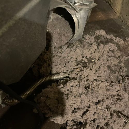 Cleaning a clogged dryer vent.