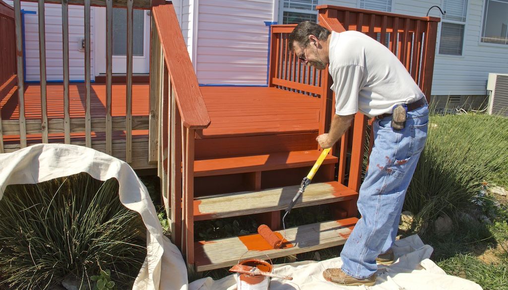 professional painters painting a deck