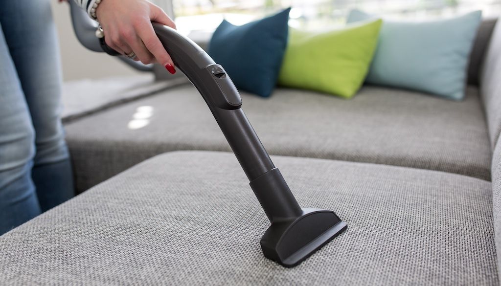 vacuuming polyester couch