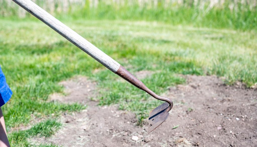 turning over soil with shovel