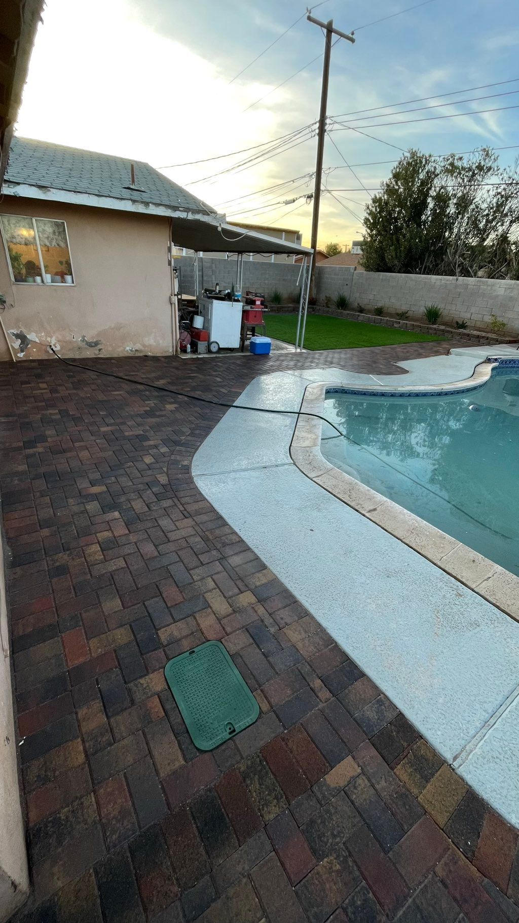 After: paver, retaining wall, plants and artificia