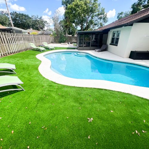Poolside oasis with lush artificial grass accents,