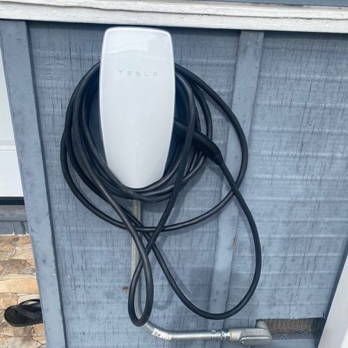 Tesla car charger installed under house to the fro