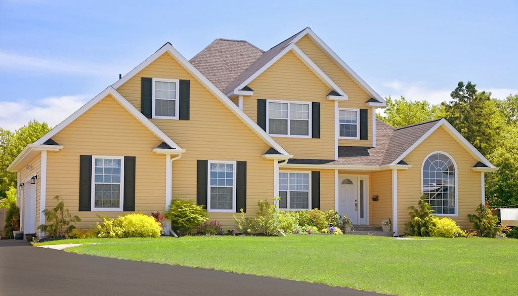 yellow house with vinyl siding