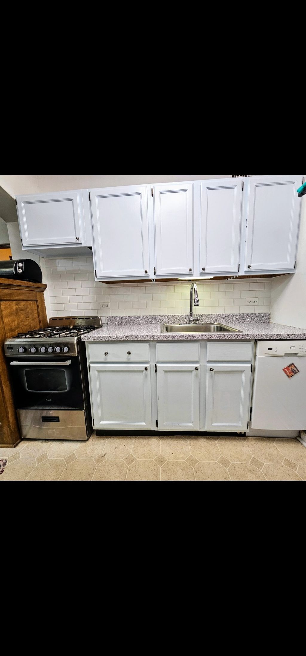 after photo of a subway white backsplash install 
