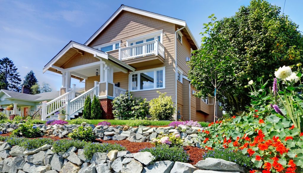 home with beautiful rock landscaping to boost curb appeal