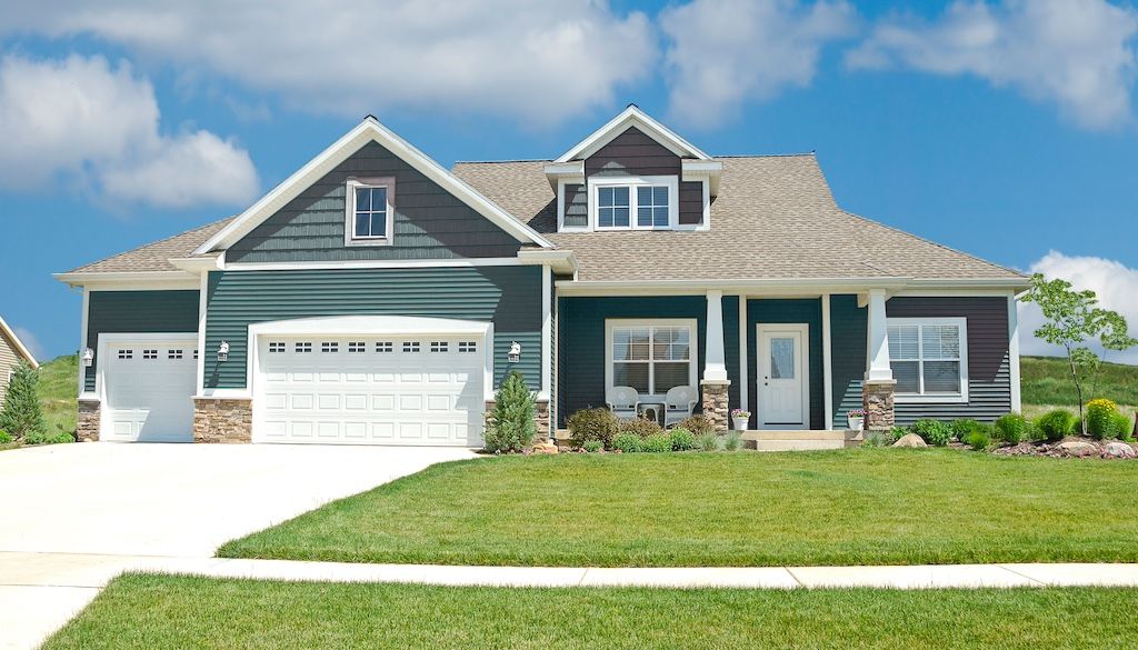 green vinyl siding home with beautiful curb appeal