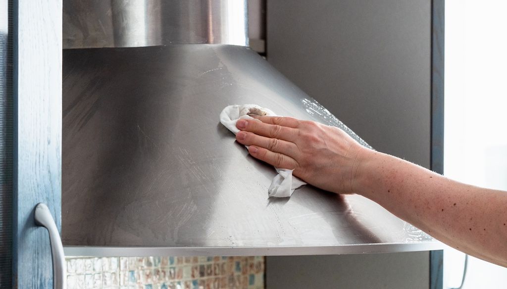 cleaning stainless steel hood in kitchen