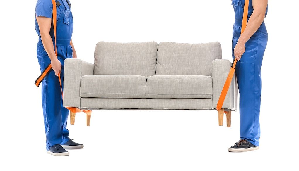 movers lifting couch with straps