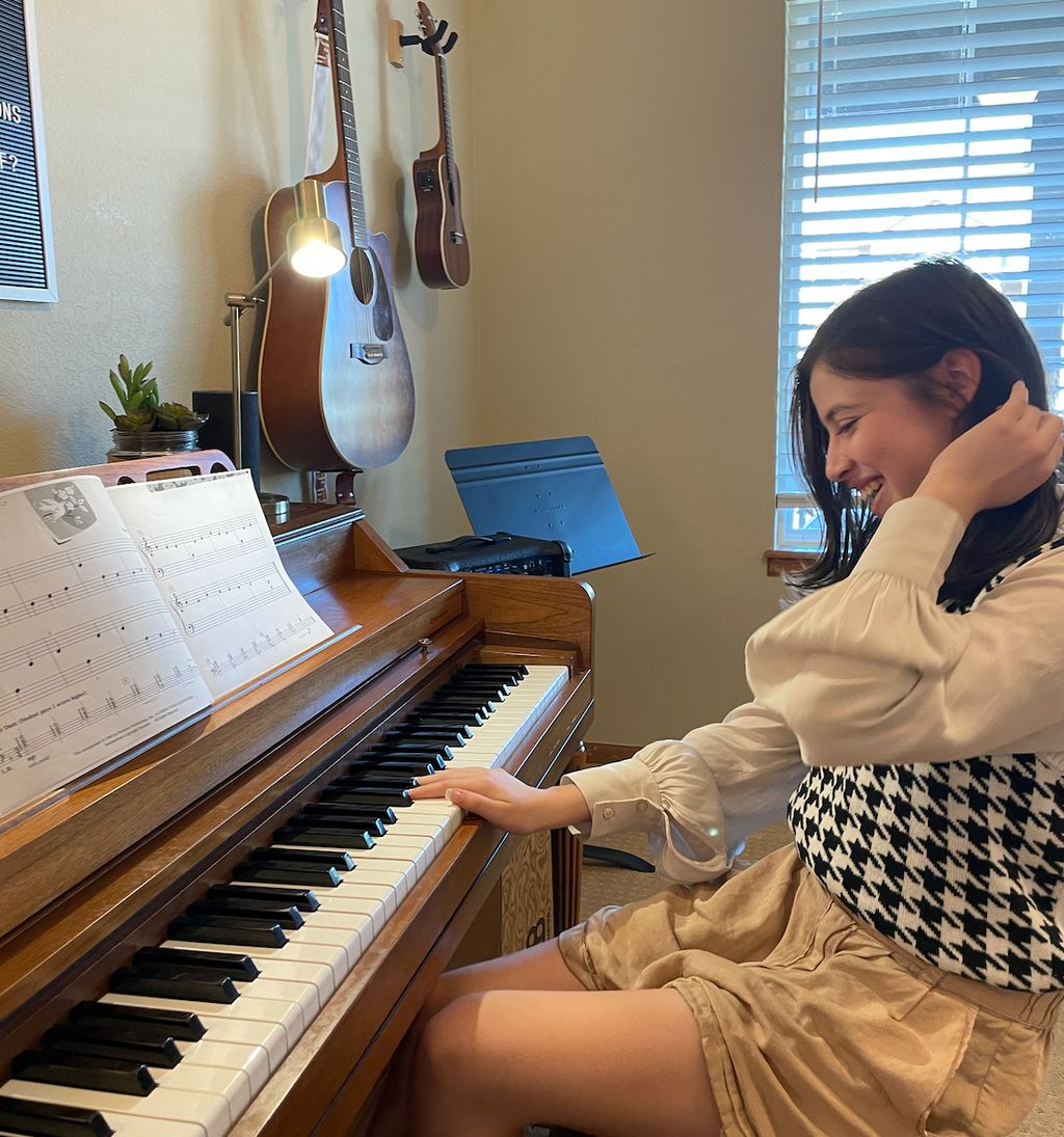 Carolena enjoys playing songs from her method book