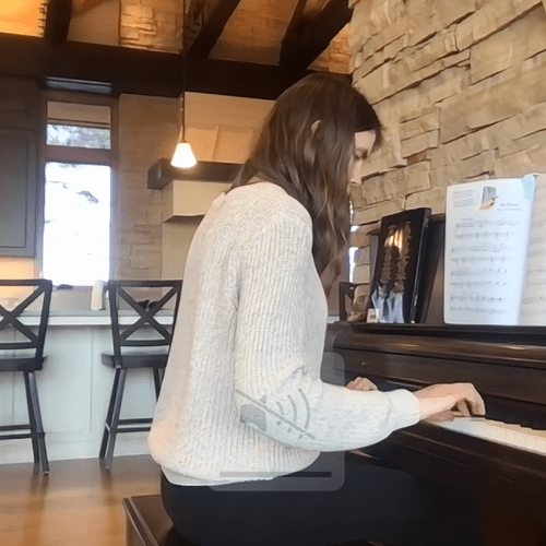 She's playing piano virtually from home while the 
