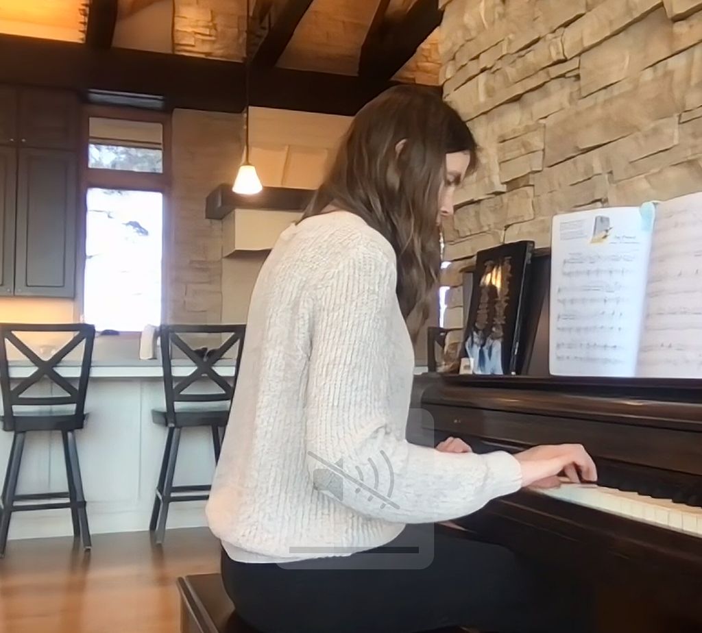 She's playing piano virtually from home while the 