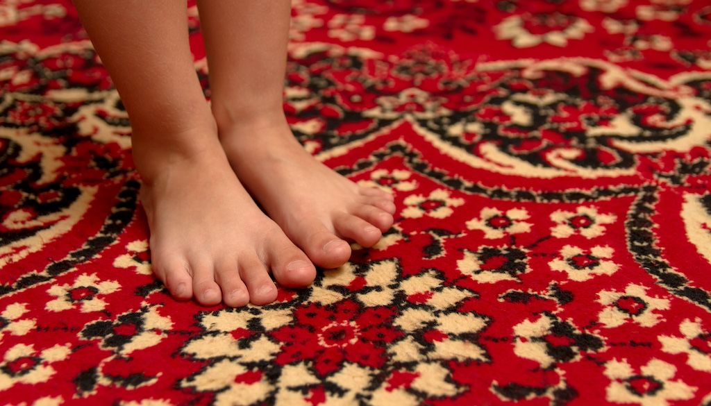 child's feet in Persian rug