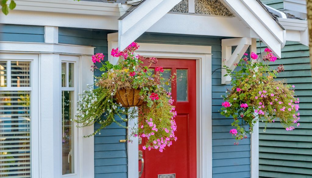 hanging planters with flowers on front porch