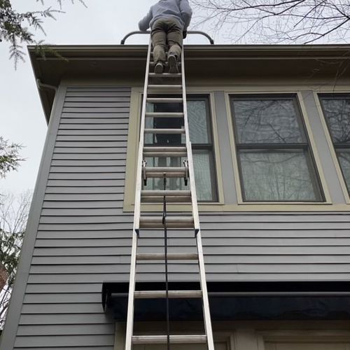 Gutter cleaning from a tall ladder