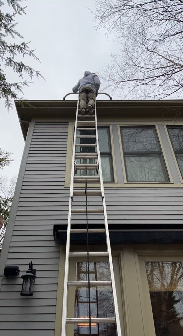 Gutter cleaning from a tall ladder