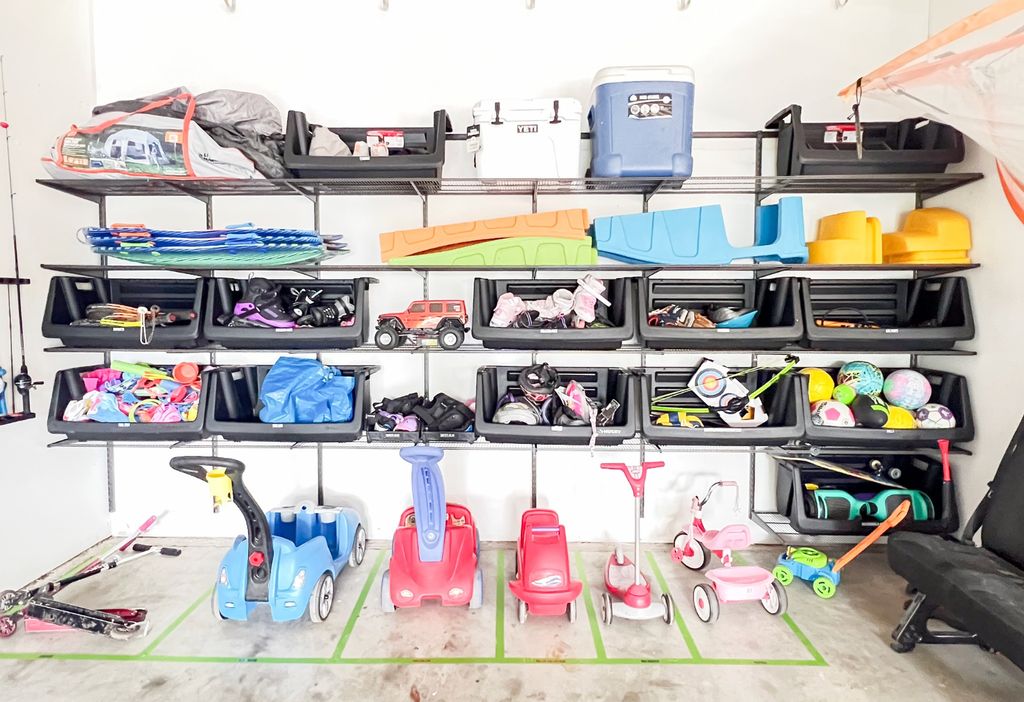 An organized garage with homes for the kids' ridin