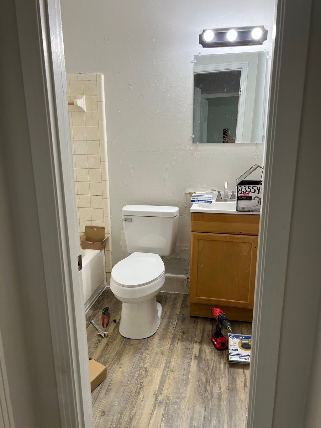 Installed: Floor, Toilet, Vanity, Mirror & Light (