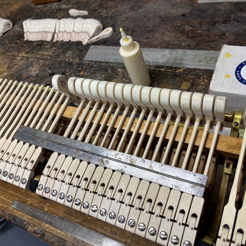 Gluing on new hammers on a Steinway action