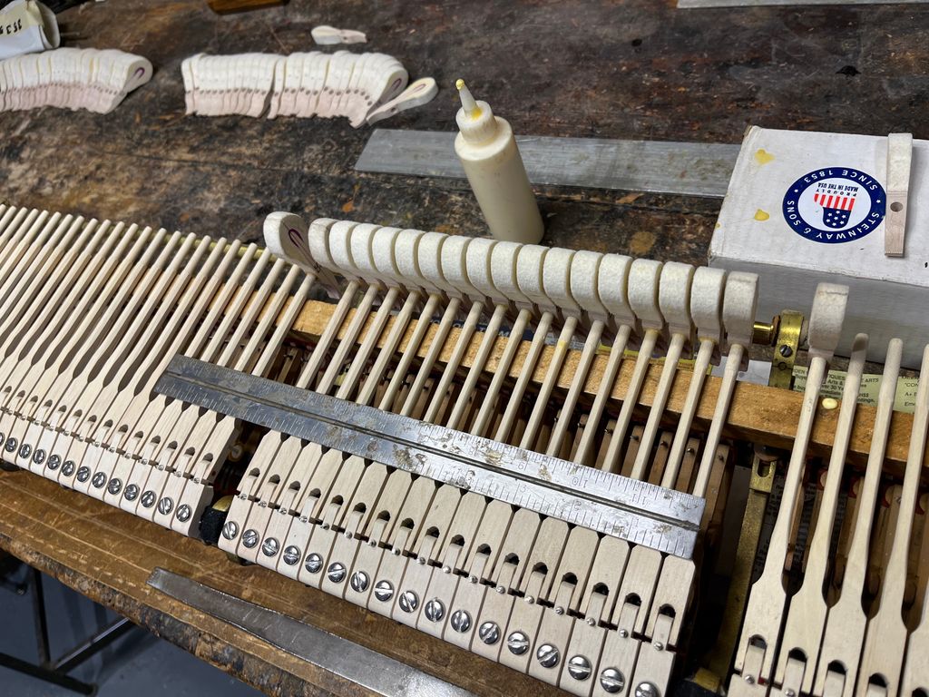 Gluing on new hammers on a Steinway action