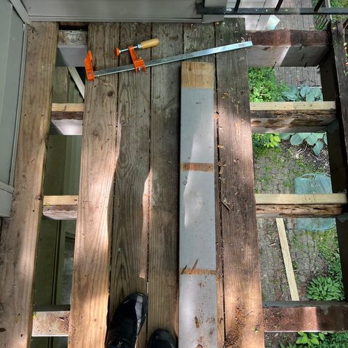 Deck mid-repair showing new joists sistered alongs