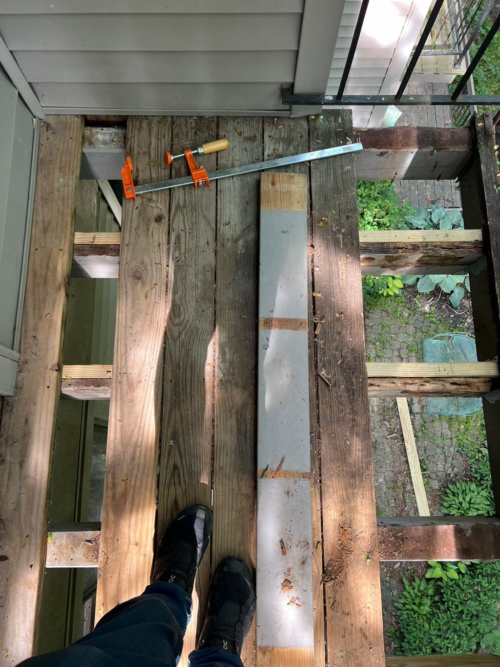 Deck mid-repair showing new joists sistered alongs