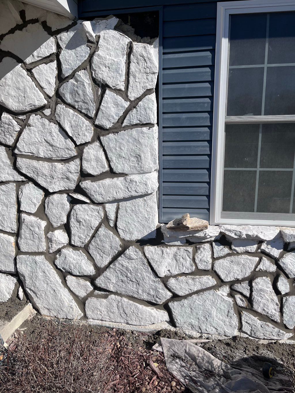 Foundation stones on house grinded out and mortar 