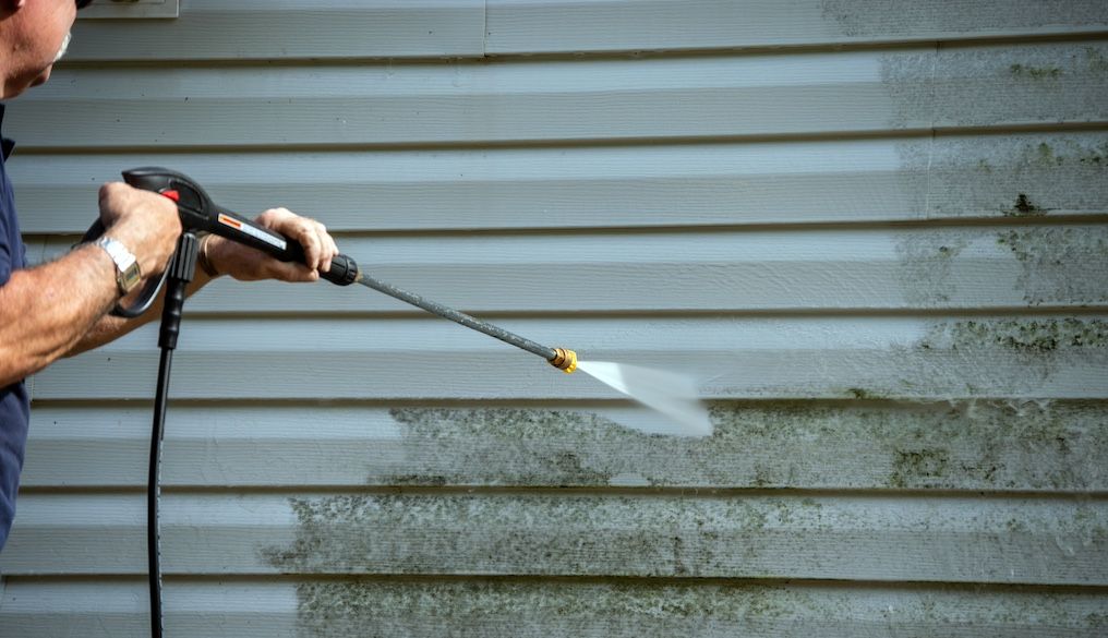 a pro pressure washing dirty vinyl siding