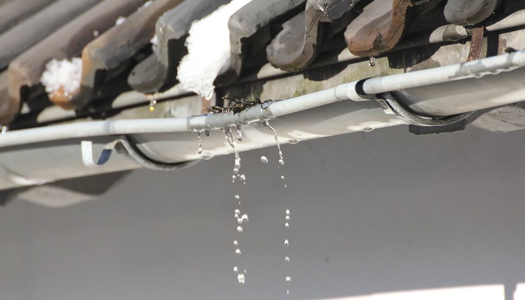 gutters sagging and broken due to branches and ice