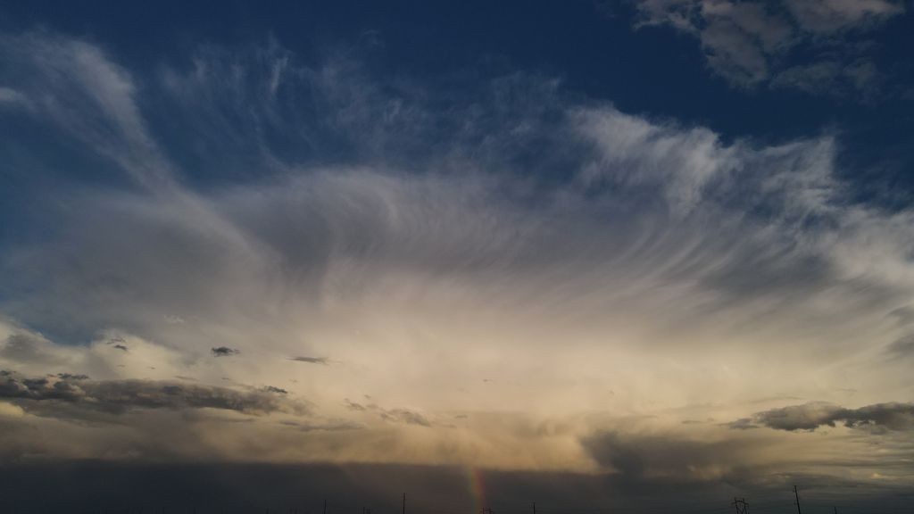 Tail end of thunderstorm with rainbow