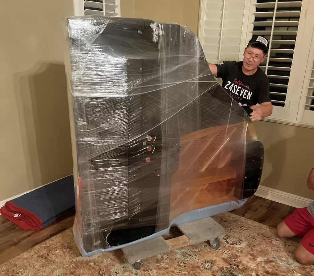 movers moving a piano