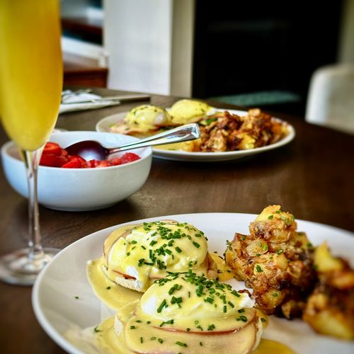 Classic brunch. Eggs Benedict, Yukon potatoes with