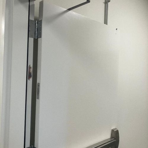 Hollow metal fire door with panic par and closer