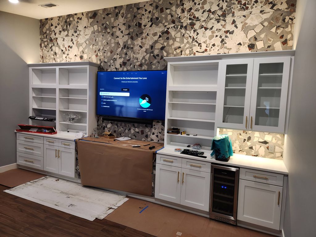 85" TV with sound bar on tile wall