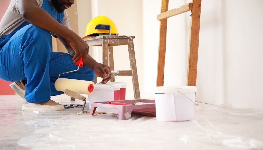 painter preparing and gathering paint supplies