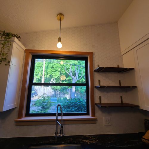 Newly installed window trim and kitchen shelves.