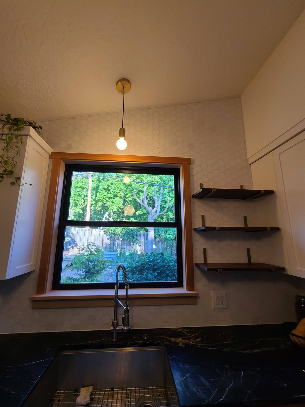 Newly installed window trim and kitchen shelves.