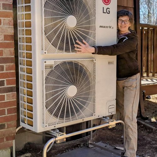 A happy customer with a new LG heat pump system in