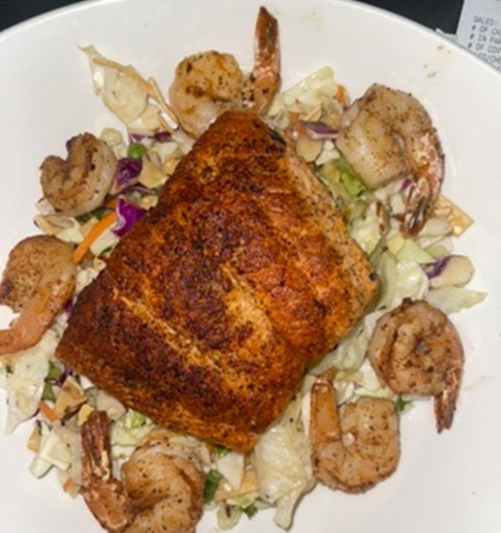 Grilled salmon and shrimp over an Asian chopped se