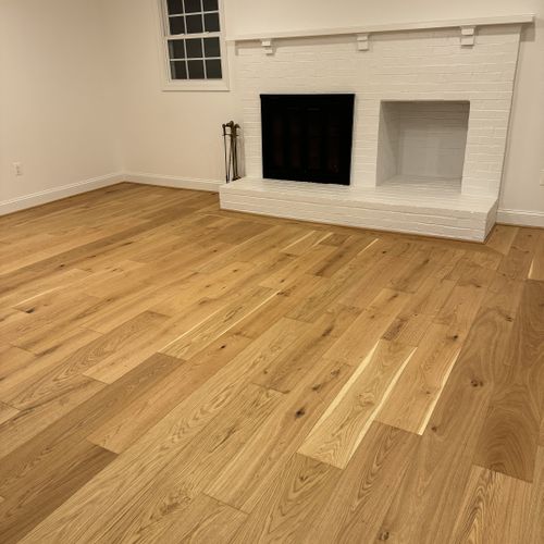 Install new natural-colored engineered wood floors