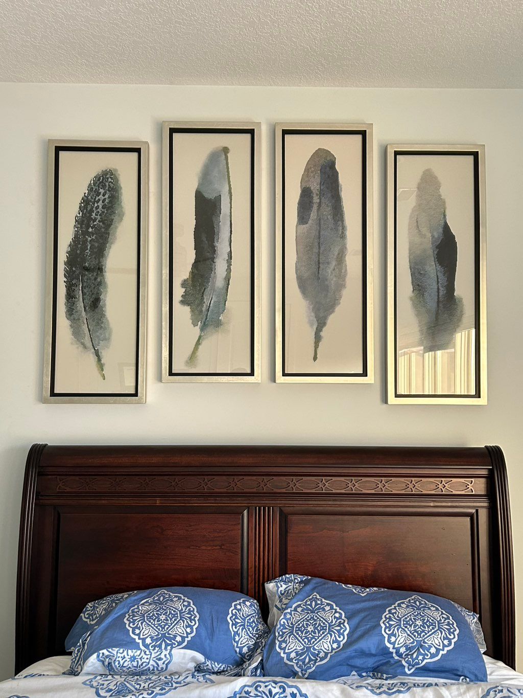 Pictures centered above bed