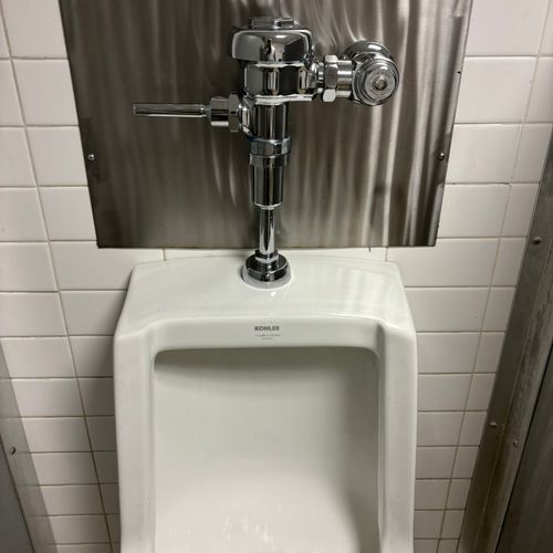 New urinal installed with a new flushometer 