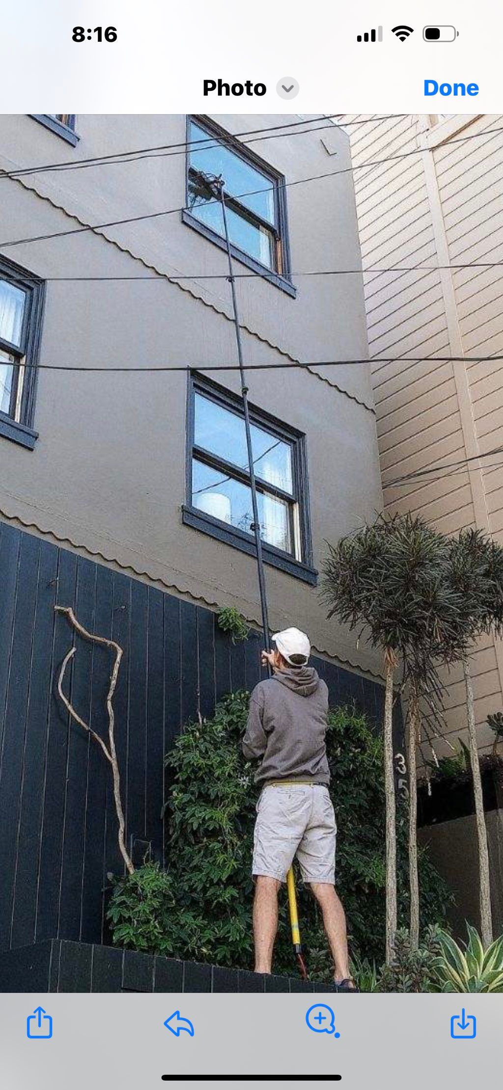 Cleaning 3rd story windows with the water-fed pole